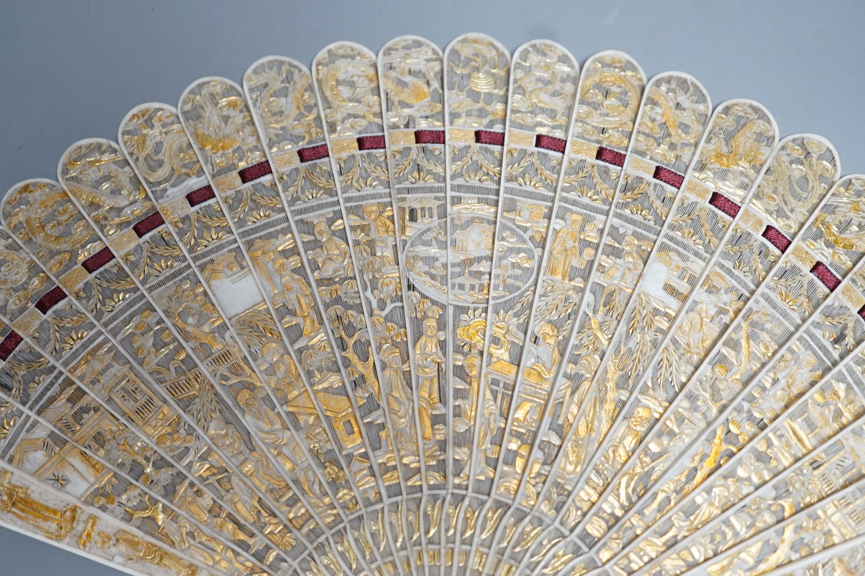 A 19th century Chinese export pierced ivory brise fan, gilded sticks, 19cm